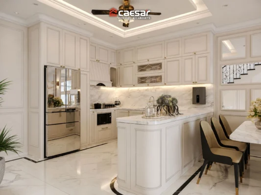 thiết kế bếp màu trắng có bàn đảo bo cong và tủ cao
